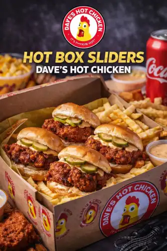 Hot Box Sliders from Dave’s Hot Chicken served with crispy chicken sliders, pickles, sauce, and fries.