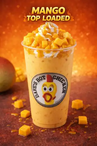 Mango Top Loaded shake from Dave’s Hot Chicken topped with fresh mango chunks and creamy swirl.